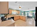 Spacious kitchen featuring wood cabinets, tile flooring, and breakfast nook with windows at 1401 Madrigal Ln, Lady Lake, FL 32159