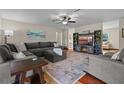 Open-concept living room with hardwood floors, fireplace, and a comfortable sectional sofa at 14325 Manchester Ave, Groveland, FL 34736