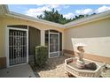 Up-close exterior shot of the front door entry and lovely front yard landscaping at 1512 Cervantes Pl, Lady Lake, FL 32159