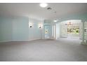Large, open-concept living space with overhead lighting and white trim; features a view to the backyard at 1512 Cervantes Pl, Lady Lake, FL 32159