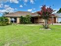 Beautiful one-story home with lush green lawn and attractive landscaping at 17329 Se 115Th Ter, Summerfield, FL 34491