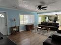 Open concept living room featuring modern wood floors and contemporary furniture at 219 Magnolia Cir, Eustis, FL 32726
