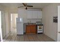 Functional kitchen features bright cabinets, appliances, and a tile floor at 2611 Hiawatha Ave, Sanford, FL 32773