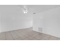 Bright living room with ceramic tile, ceiling fan, and fresh paint at 302 W Rose Ln, Lady Lake, FL 32159