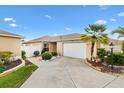 Charming single-Gathering home featuring an attached garage and beautiful landscaping on a sunny day at 3105 Carrollton Ct, The Villages, FL 32162