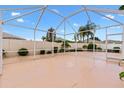 Spacious screened patio ideal for outdoor gatherings, surrounded by a privacy wall and lush greenery at 3105 Carrollton Ct, The Villages, FL 32162