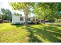 Well-maintained home with lush lawn and mature trees providing ample shade at 36812 Skycrest Blvd, Fruitland Park, FL 34731
