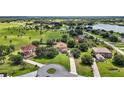 Expansive aerial view showcasing a sprawling estate with lush green landscaping and waterfront views at 36914 Bee Meadow Ct, Eustis, FL 32736