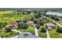Expansive aerial view showcasing a sprawling estate with lush green landscaping and waterfront views at 36914 Bee Meadow Ct, Eustis, FL 32736