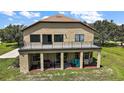 Stunning outdoor living space with balcony, covered patio, dining area, and grill at 36914 Bee Meadow Ct, Eustis, FL 32736