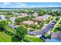 Aerial view of a property surrounded by lush greenery and situated near a serene lake at 418 Rock Springs Cir, Groveland, FL 34736