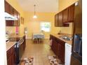 Eat-in kitchen with tile floors and stainless steel appliances at 5016 Mcdonald Rd, Zellwood, FL 32798