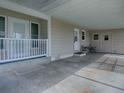Covered carport featuring a seating area and multiple entry points at 601 Jason Dr, The Villages, FL 32159