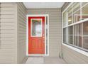 Inviting front door with decorative glass window and sidelight, framed by neutral siding at 6640 Sw 85Th Pl, Ocala, FL 34476