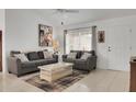 Comfortable living room with neutral decor, ceiling fan, and natural light at 670 Fayette Ct, The Villages, FL 32162