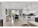 Open-concept floor plan with tiled floors and an adjacent dining area at 670 Fayette Ct, The Villages, FL 32162