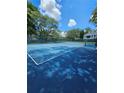 Community tennis court surrounded by mature trees at 711 Sugar Bay Way # 115, Lake Mary, FL 32746