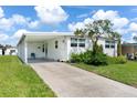 Single-story home featuring covered parking and well-maintained landscaping at 717 W Coach N Four Dr, Leesburg, FL 34748