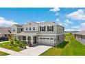Charming two-story home featuring a two-car garage and a beautifully landscaped front yard at 872 Griffon Ave, Lake Alfred, FL 33850