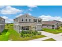 Attractive two-story home featuring a front yard with lush, green landscaping at 872 Griffon Ave, Lake Alfred, FL 33850