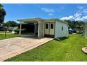 Charming single-story home featuring a covered carport and well-maintained landscaping at 902 Rose Ln, Lady Lake, FL 32159