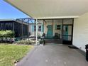 Inviting screened porch with neutral decor, complemented by a cooling ceiling fan at 902 Rose Ln, Lady Lake, FL 32159