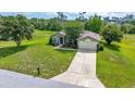 Well-kept home has a lush green lawn, mature landscaping, and extended driveway at 10331 Sw 45Th Ave, Ocala, FL 34476