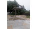 Covered carport with basketball hoop and concrete base at 11532 Beaman Cir, Clermont, FL 34711