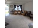 Cozy living room with comfortable seating and natural light streaming through the window at 149 Roseling Xing, Davenport, FL 33897