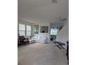 Living room with white sofa set, bench and artwork on the white walls at 149 Roseling Xing, Davenport, FL 33897