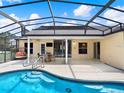 Sparkling screened-in pool with a spacious patio area, perfect for outdoor entertaining at 25400 Waterbrook Ct, Leesburg, FL 34748