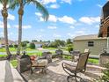 Inviting front porch with a stone base, outdoor seating, and tranquil views of the neighborhood at 2620 Persimmon Loop, The Villages, FL 32162