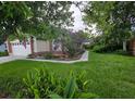 Well-manicured front yard showcasing vibrant landscaping and mature trees at 2842 Ithaca Ct, Orlando, FL 32826