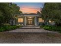 Charming home featuring a stone pathway leading to a covered front porch with classic columns at 32511 County Road 437, Sorrento, FL 32776