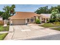 Single-story home boasting a well-maintained lawn, mature trees, and a spacious two-car garage at 3309 Paisley Cir, Orlando, FL 32817