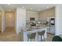 Modern kitchen featuring stainless steel appliances, granite countertops, a center island, and ample cabinet space at 5002 Abigail Dr, Lake Wales, FL 33859