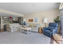 Inviting living room with comfortable floral sofas, a recliner, and a partial view of the kitchen at 601 N Mcdonald St # 2, Mount Dora, FL 32757