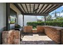 Covered patio area with a built-in brick grill, perfect for outdoor cooking and entertaining at 621 Lost Grove Cir, Winter Garden, FL 34787