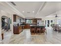 Spacious kitchen featuring an island with seating and stainless steel appliances and tile floors at 628 Drew Ave, Clermont, FL 34711