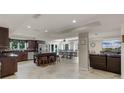 Spacious kitchen featuring a large island, stainless steel appliances, and adjacent dining area at 628 Drew Ave, Clermont, FL 34711