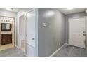 Hallway view showcases the bathroom, linen closet, and access to the backyard at 8634 Garden Way Rd, Groveland, FL 34736