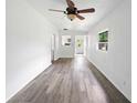 Bright living room with modern gray wood flooring and ceiling fan at 1134 Cr 464, Lake Panasoffkee, FL 33538