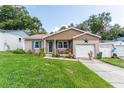 Charming home featuring a manicured lawn, brick accents, and an inviting covered porch with seating at 149 Shiloh Ave, Lady Lake, FL 32159