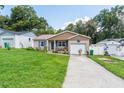 Charming home featuring a manicured lawn, brick accents, and an inviting covered porch with seating at 149 Shiloh Ave, Lady Lake, FL 32159