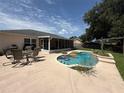 Inviting backyard pool area with a screened lanai, perfect for outdoor entertaining and relaxation at 15349 Lafite Ln, Clermont, FL 34714