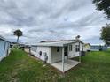 Features a well-maintained yard, utility connections, and an aluminum roof in a quiet residential community at 163 Sweet Cir, Winter Haven, FL 33884