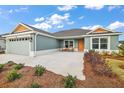 Inviting single-story home with well-maintained lawn and landscaping, showcasing its appealing curb appeal at 2055 Merideth Ter, The Villages, FL 34762