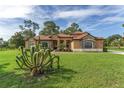 Beautiful home with a well-maintained lawn and unique plants adding character to the property at 21312 Marsh View Ct, Clermont, FL 34715