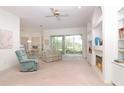 Bright living room featuring a fireplace, built-in shelving, and sliding glass doors leading to the backyard at 22125 Draw Bridge Dr, Leesburg, FL 34748