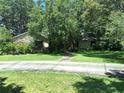 Beautiful home featuring mature landscaping, a mix of stone and siding, and a long driveway at 29205 Old E Ml, Tavares, FL 32778